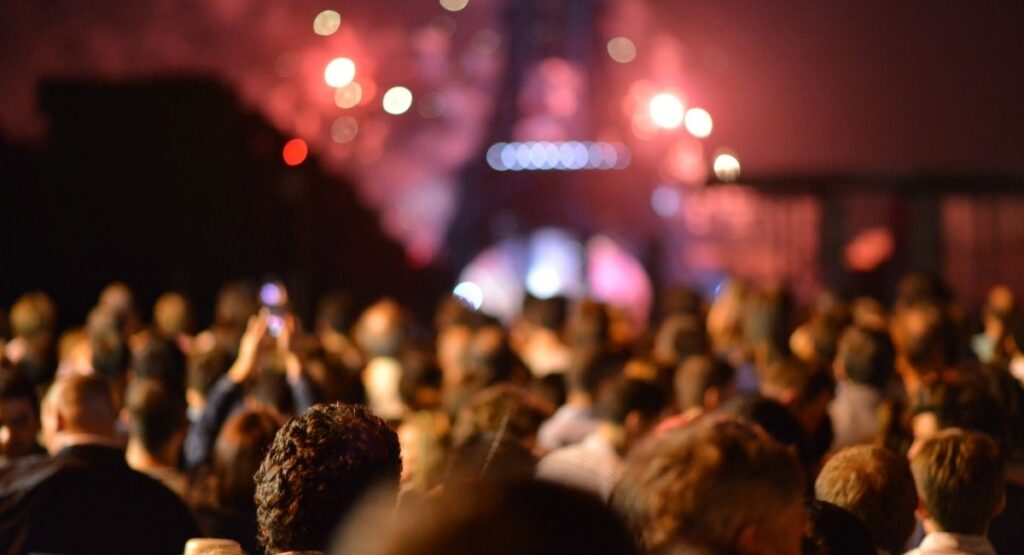 a group of people looking at the music stage