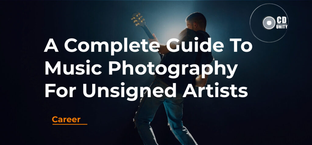 A Complete Guide To Music Photography For Unsigned Artists 13 A musician playing guitar on stage with dramatic lighting, overlaid with the text "A Complete Guide To Music Photography For Unsigned Artists" and the CD Unity logo.