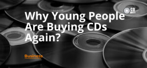 CD cover printing 40 Stack of compact discs with the text “Why Young People Are Buying CDs Again?” in large letters and “Business” in orange below.